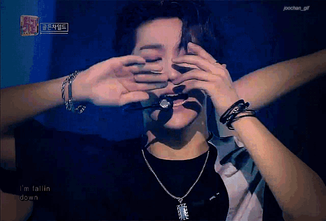 a person covering another person 's eyes with their hands and the words i 'm fallin down below them