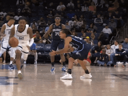 a basketball player with the number 34 on his jersey is dribbling the ball
