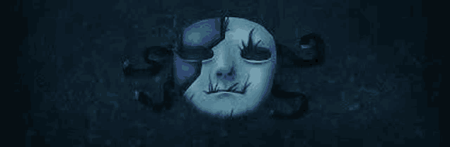 a blue and white mask with a skull on it is sitting on a dark surface .