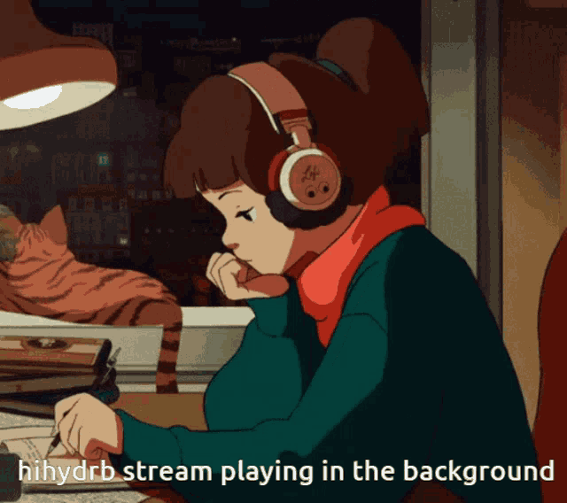 a girl wearing headphones is sitting at a desk with a cat in the background