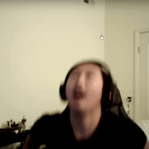 a blurry picture of a person wearing headphones with a white arrow pointing to the left
