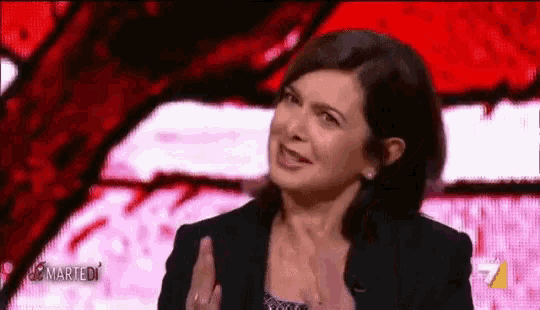a woman in a black jacket is talking on a television show called martedi