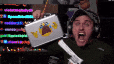 a man is holding a briefcase with a crying face on it