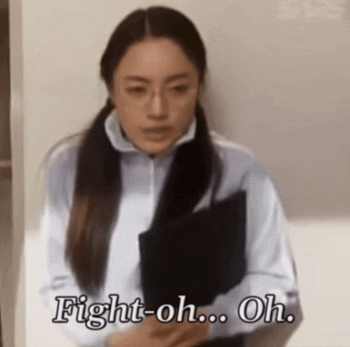 a woman is holding a folder and says fight-oh oh
