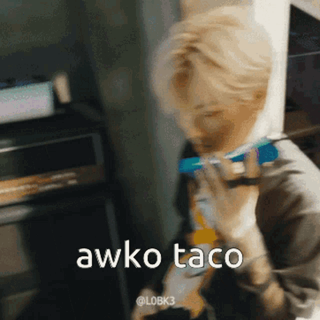 a blurry picture of a person with the words awko taco on it