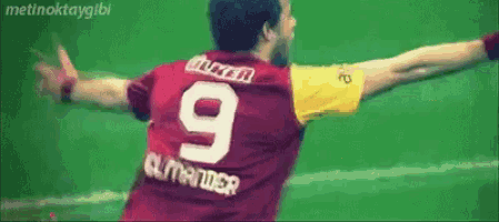 a man wearing a red and yellow jersey with the number 9 on the back
