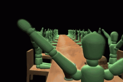 a group of green mannequins are sitting at a long table with their arms in the air