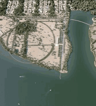 an aerial view of a large body of water surrounded by houses and trees