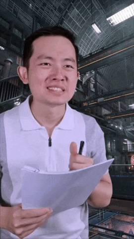 a man holding a piece of paper and a pen