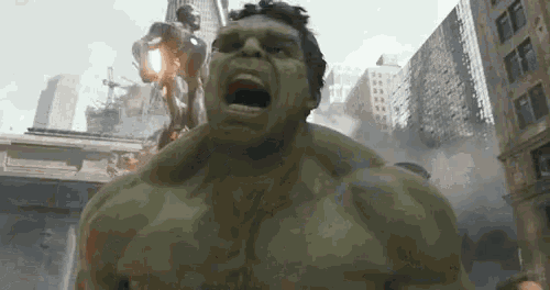 the hulk is standing in front of a city with his mouth open