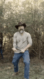 a man with a beard wearing a cowboy hat is dancing