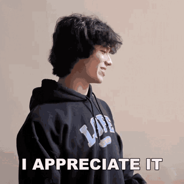 a man wearing a black hoodie with the words i appreciate it written on it
