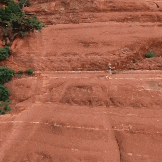 a man with a beard is running in front of a mountain ..