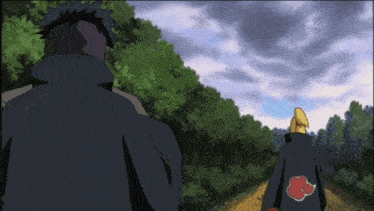 a man in a black cape with a red cloud on the back