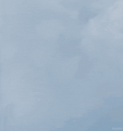 a blurred image of a person 's head with a cloudy sky in the background .