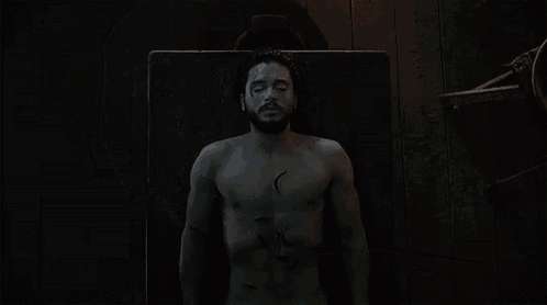 a shirtless man with a beard and a scar on his face is making a funny face .