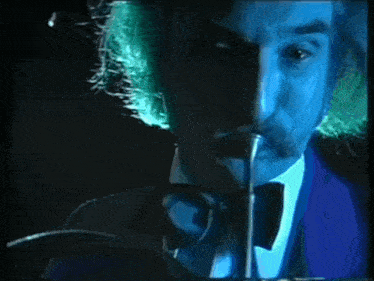 a close up of a man 's face with a blue light shining on it