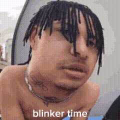 a shirtless man with dreadlocks is making a funny face with the words blinker time .