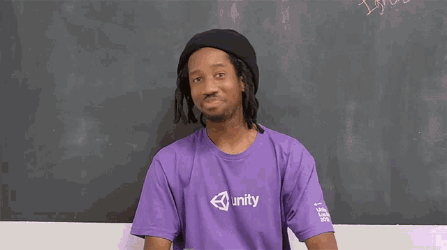 a man wearing a purple shirt with unity on it