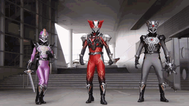 a man in a red suit stands next to a woman in a purple suit and a man in a black suit