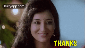 a woman is smiling in front of a christmas tree and the words thanks are on the bottom of the screen