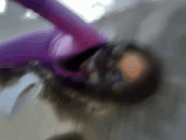 a blurry picture of a person in a purple suit and mask