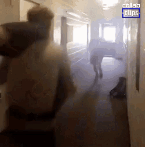 a group of people walking down a hallway with collab clips written on the bottom right