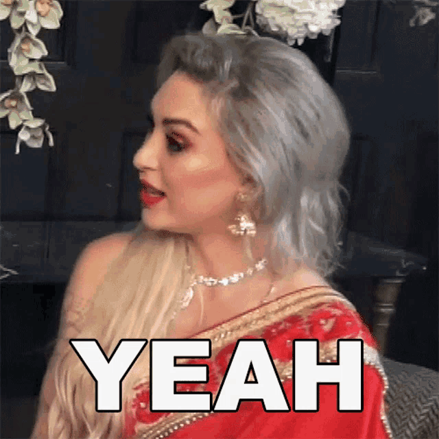 a woman in a red saree says the word yeah
