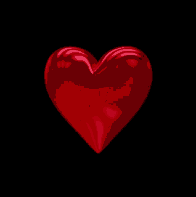 a red heart on a black background with a shiny finish
