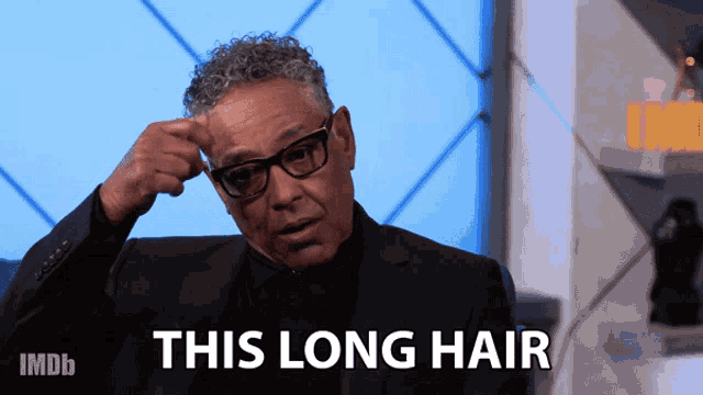 a man in a suit says this long hair
