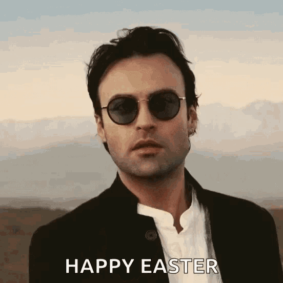 a man wearing sunglasses and a black jacket says " happy easter "