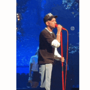 a man singing into a microphone with the words happy birthday written below him