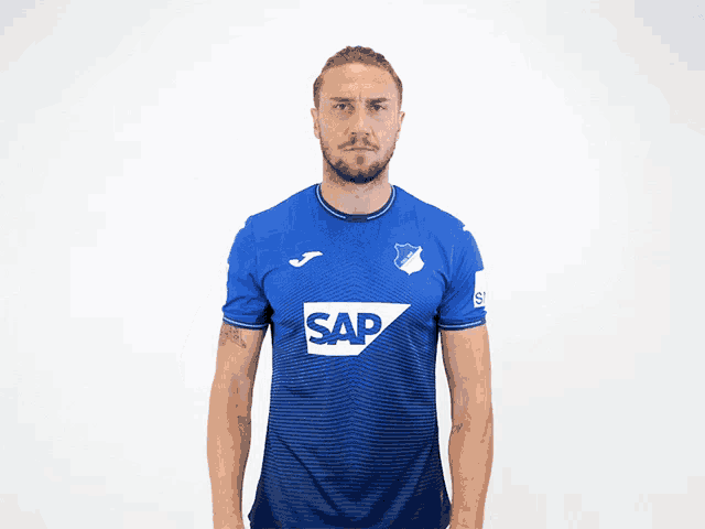 a man is wearing a blue shirt with the word sap on it