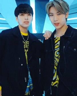 two young men standing next to each other with one wearing a shirt that says ' kf ' on it
