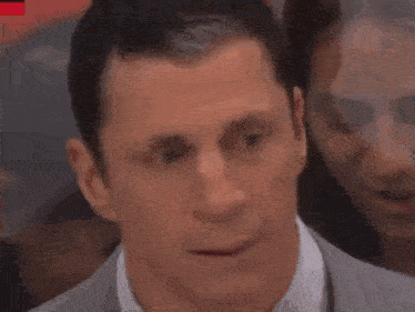 a close up of a man 's face with his eyes closed and his mouth open .