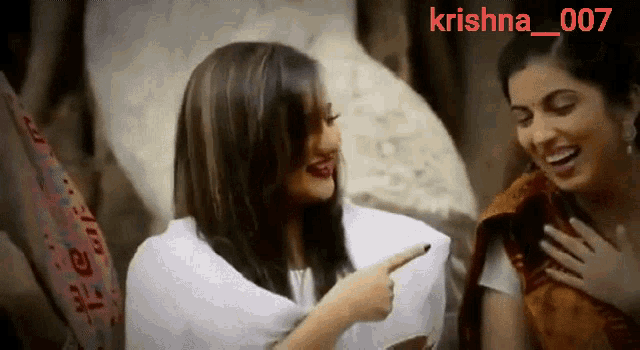 two women are laughing and one is pointing at the other with the name krishna 007 on the bottom