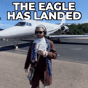 a man standing in front of a plane that says the eagle has landed on it