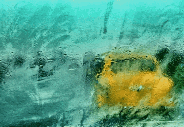 a yellow car is reflected in a window with a blue background