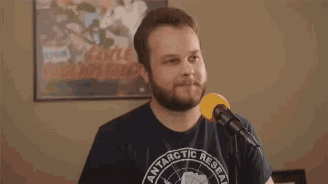 a man with a beard wearing a shirt that says sure