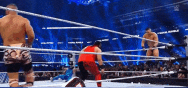 wrestlers in a ring with the words royal rumble on the bottom
