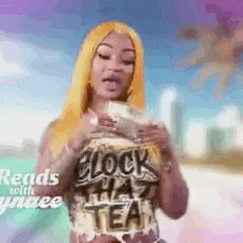 a woman with blonde hair is holding a bag of money in her hand .