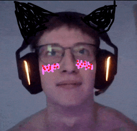 a man wearing glasses and headphones has a cat ear sticker on his face