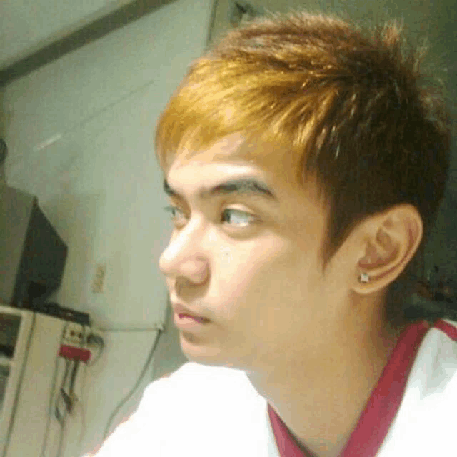 a close up of a man 's face with a white shirt and a red collar