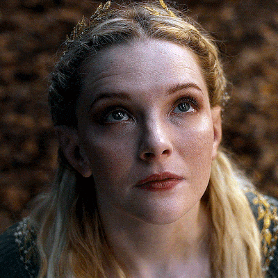 a close up of a woman 's face with a crown in her hair
