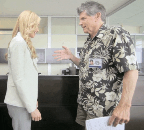 a man wearing a hawaiian shirt has a name tag that says robert