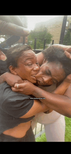 a woman is making a face while hugging another woman .