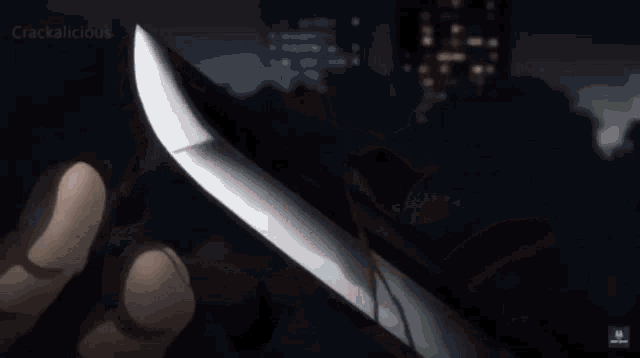 a person holding a knife in their hand with crackalicious written on the bottom of the screen