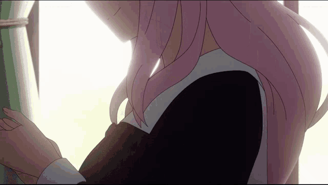 a girl with pink hair looks out a window