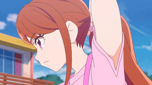 a girl with long brown hair and purple eyes holds her arm up