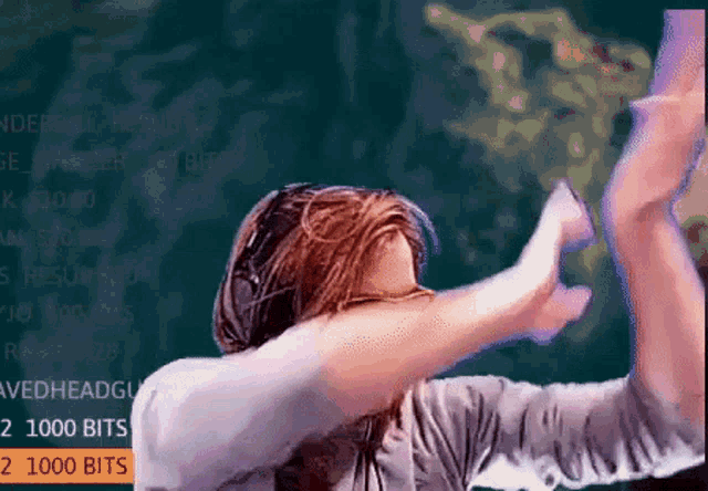 a man is dancing in front of a screen that says ' 2 1000 bits ' at the bottom